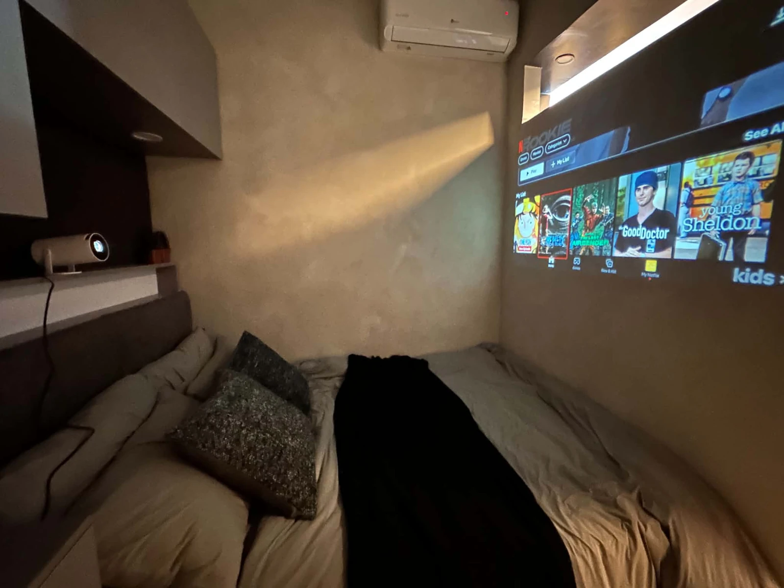 Bedroom projector displaying streaming entertainment at MONO/LITH