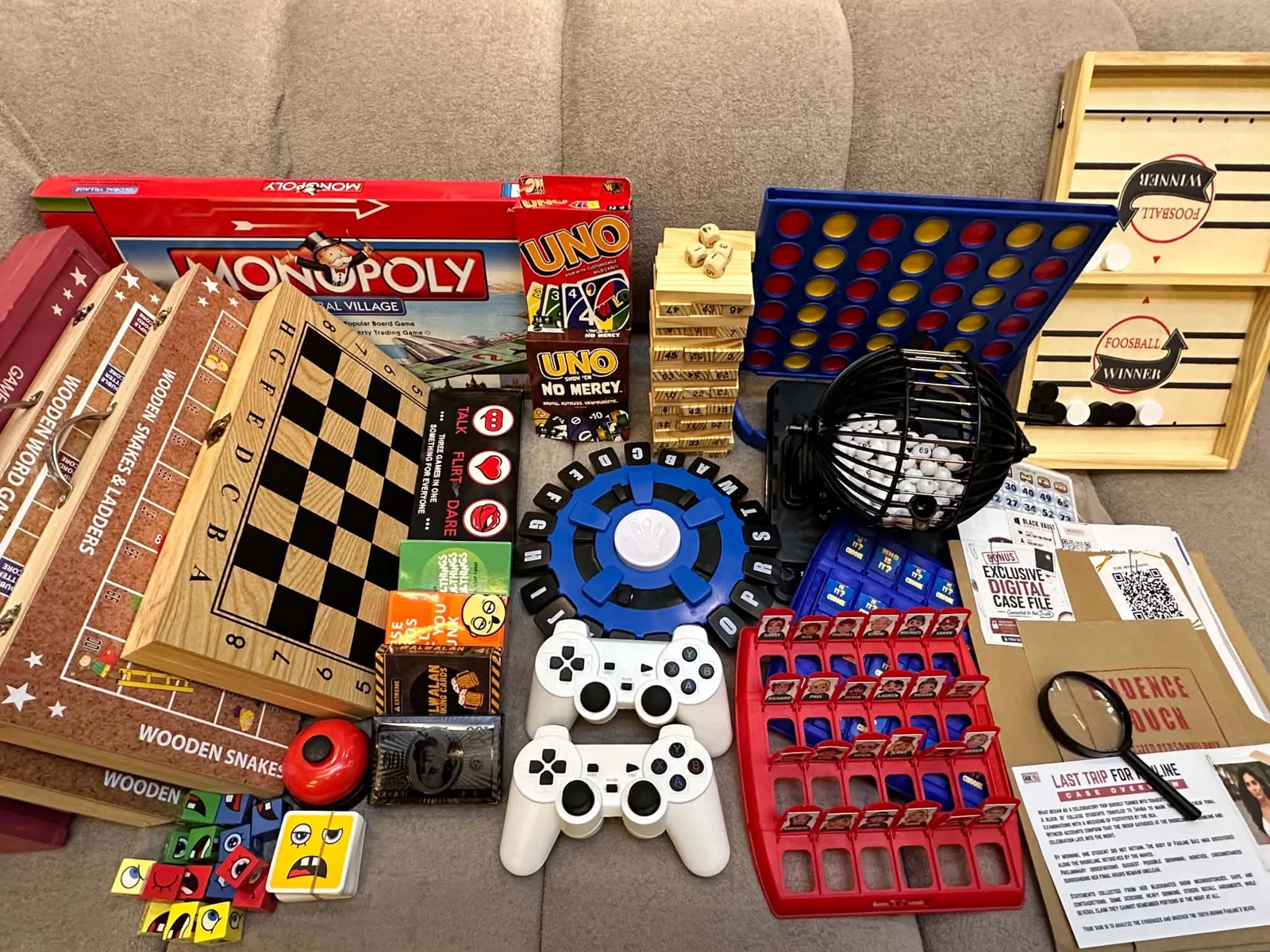 Actual guest game collection including board games, cards, bingo, tabletop games, puzzles, mystery case files and retro controllers