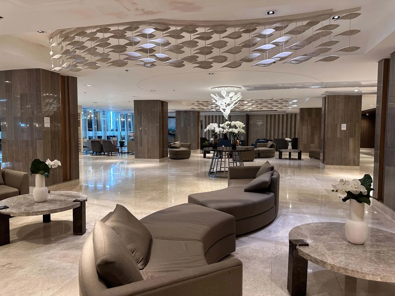 Actual Shore 3 lounge with curved sofas and ceiling details