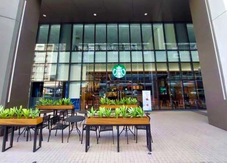 Outdoor seating and entrance at Starbucks SM Retail HQ Building B